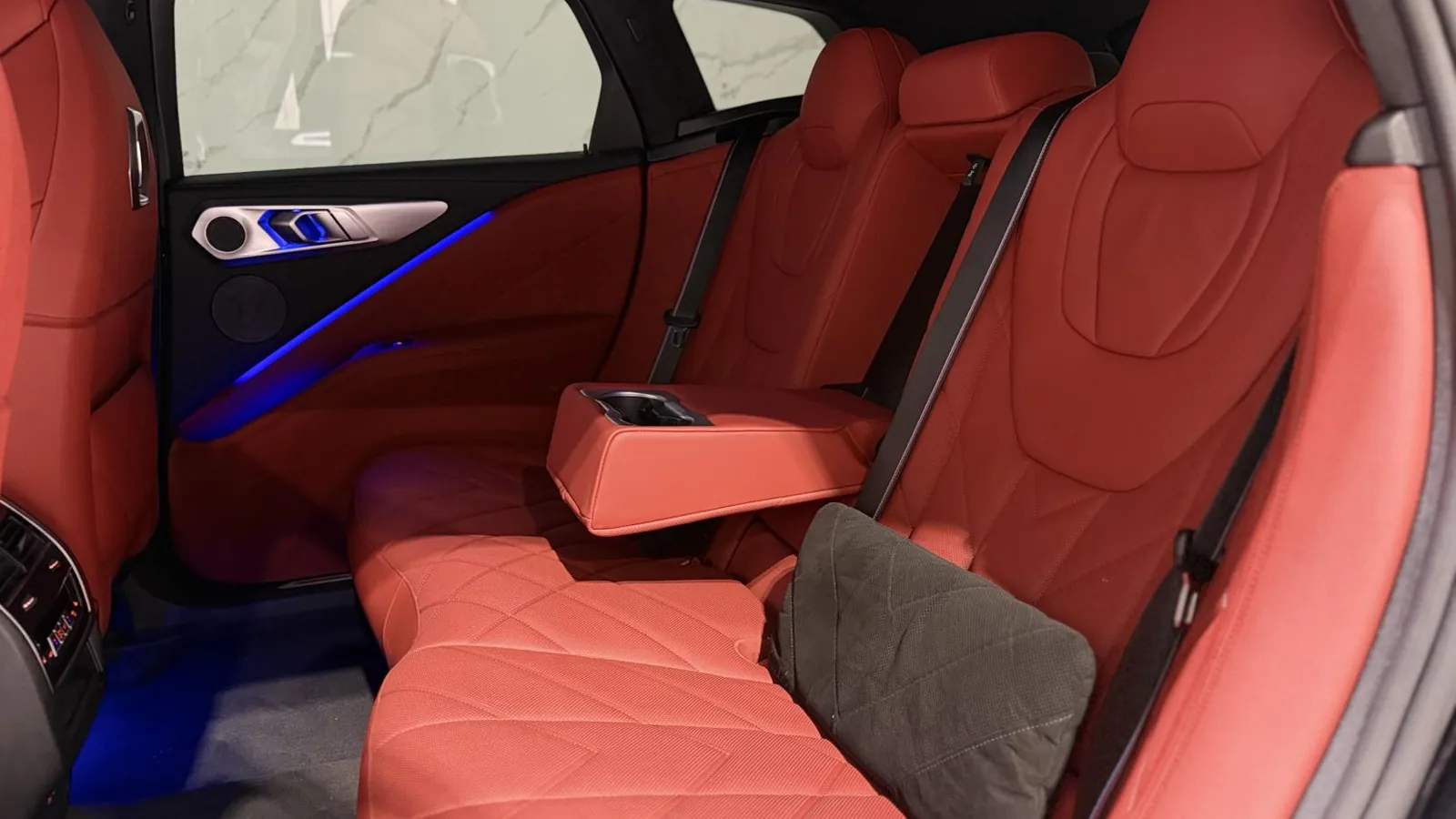 2024 BMW XM — Rear seats in tan leather with the centre armrest folded down