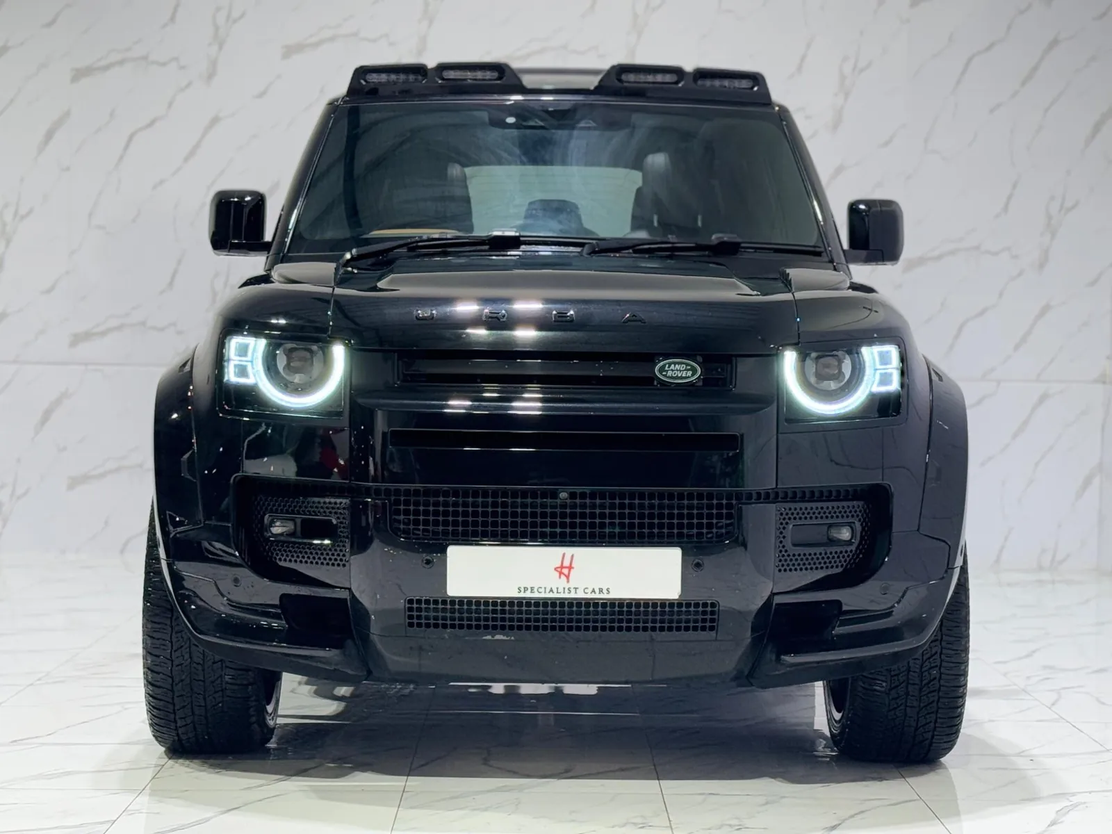 2023 Land Rover Defender 110 — Head-on view of the grille and round headlights