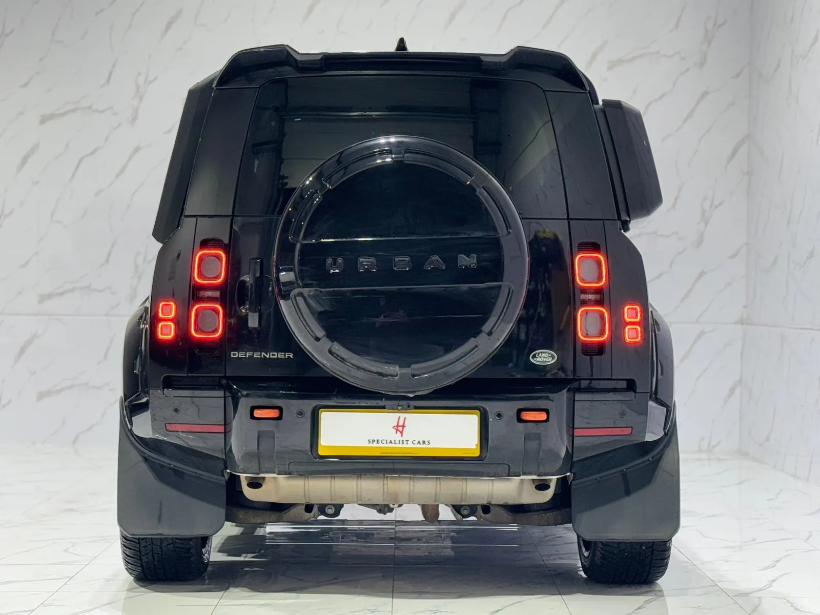 2023 Land Rover Defender 110 — Rear view showing the URBAN lettering on the spare wheel cover