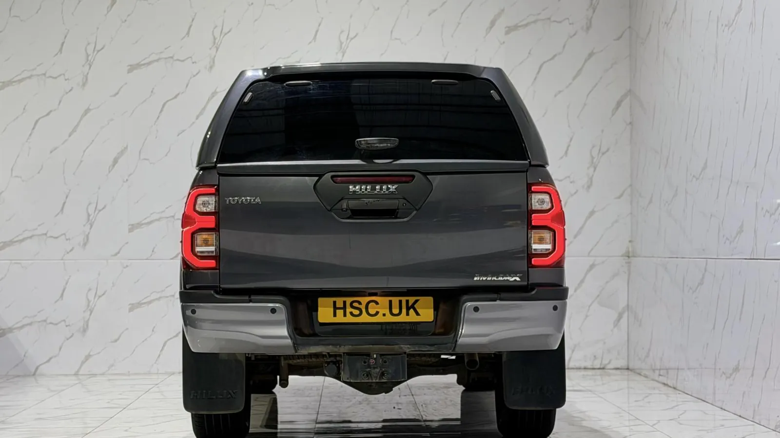 2023 Toyota Hilux — Rear view showing the canopy door and tail lights