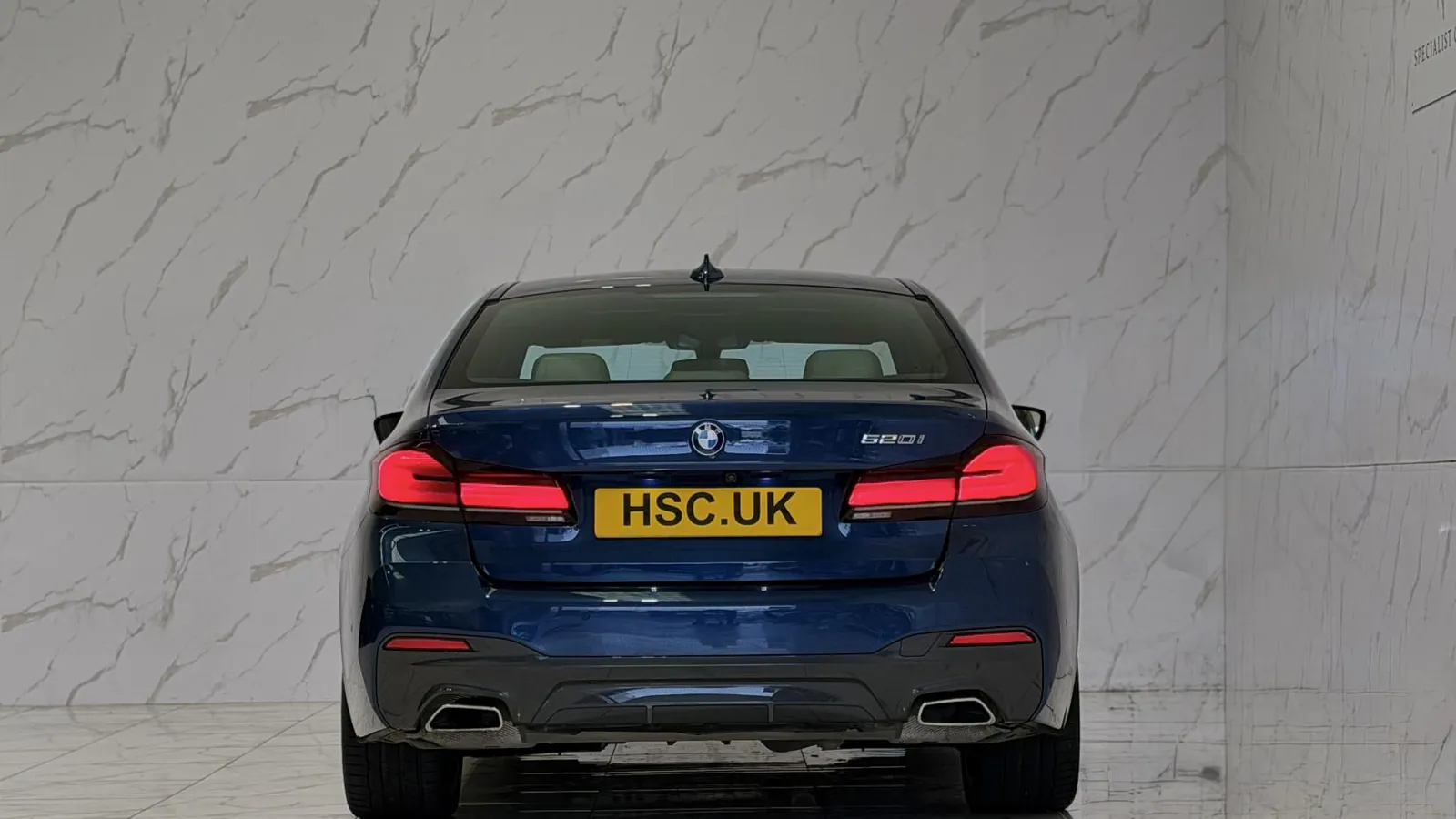 2022 BMW 5 Series — Rear view showing the tail lights and exhaust outlets
