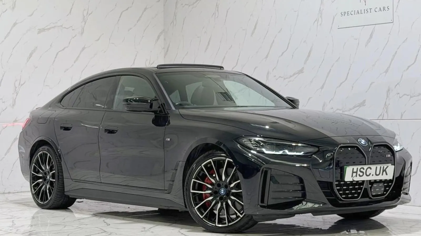 2023 BMW i4 — Front three-quarter view of the black i4 M50 on the showroom floor