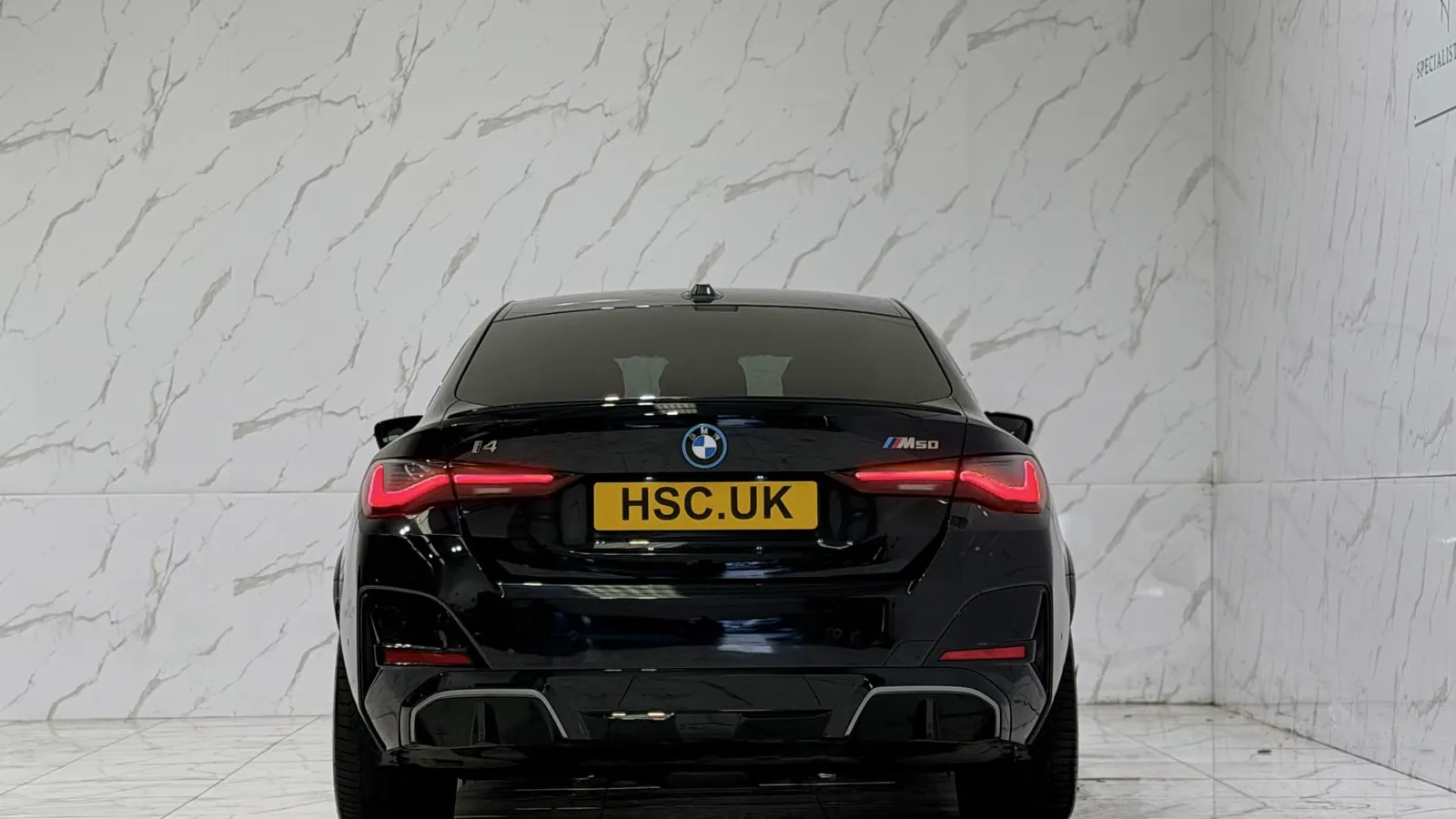 2023 BMW i4 — Rear view showing the tail lights and lower valance