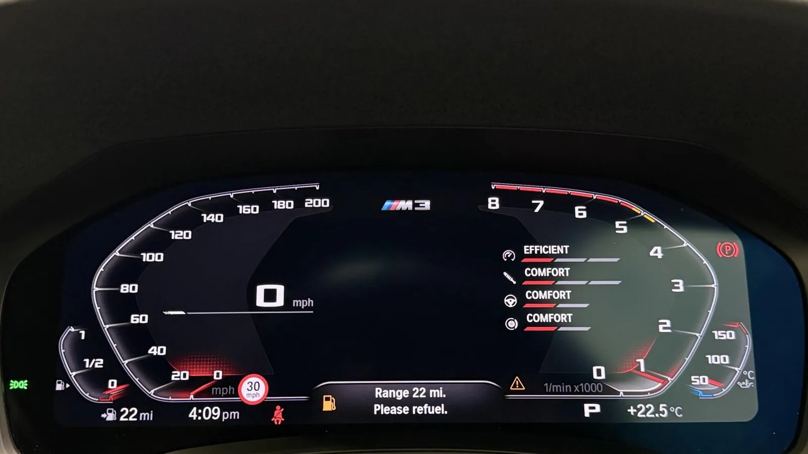 2022 BMW M3 — Instrument display showing the drive-mode settings and a 22-mile range