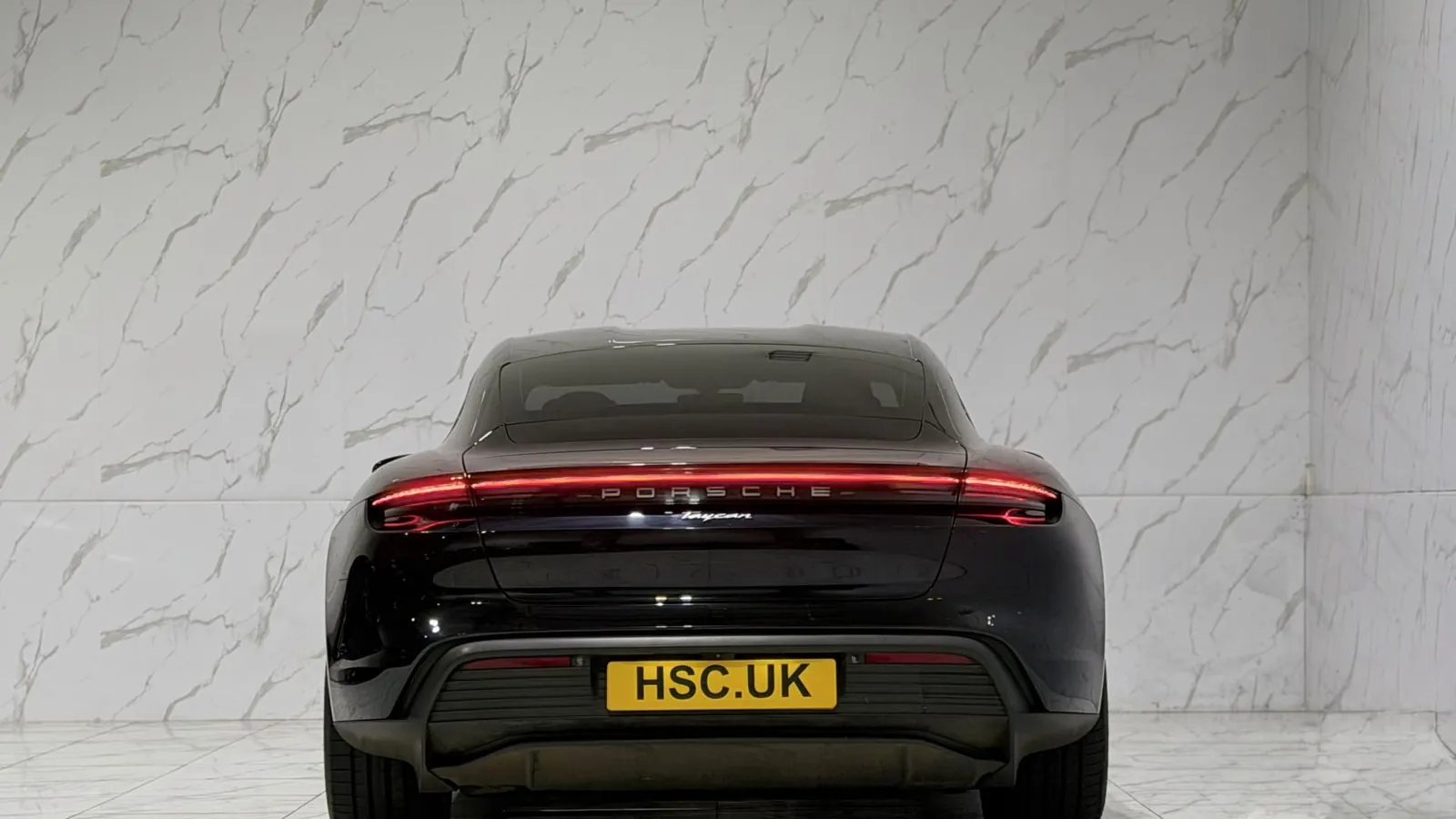 2022 Porsche Taycan — Rear view showing the full-width light bar