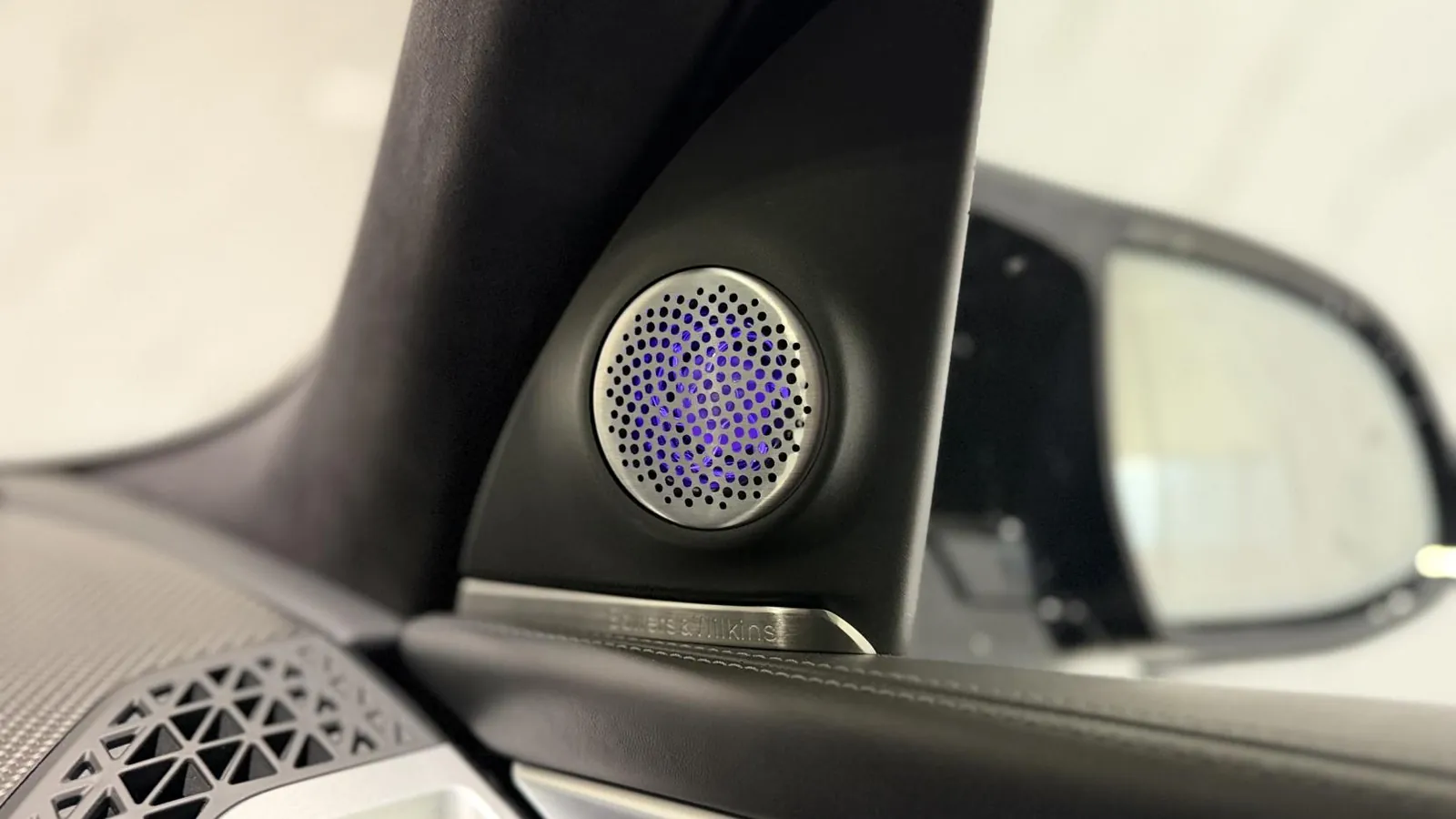 2023 BMW XM — Close view of a speaker grille in the door mirror sail panel