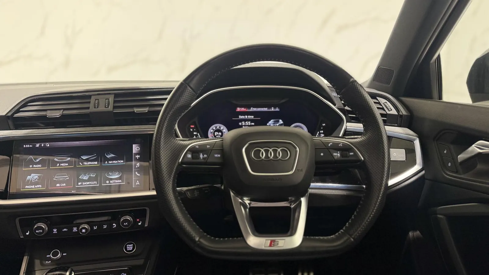 2020 Audi Q3 — Steering wheel and instrument display seen from the driver's door