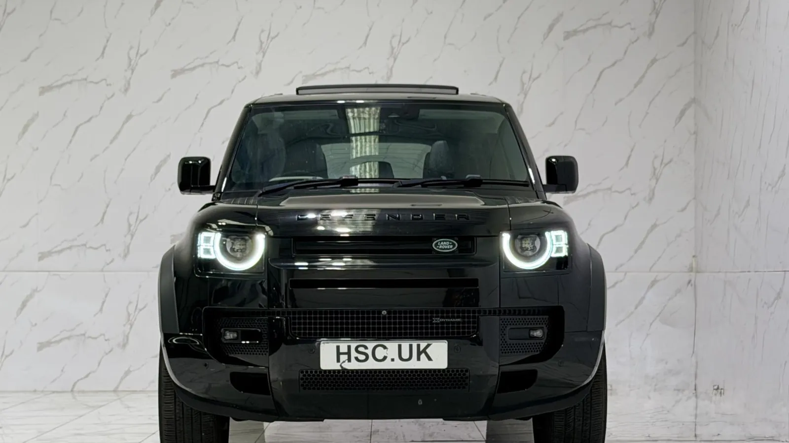 2021 Land Rover Defender 110 — Head-on view of the grille and round headlights