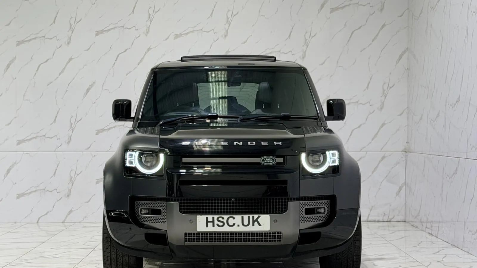 2022 Land Rover Defender 110 — Head-on view of the grille and round headlights