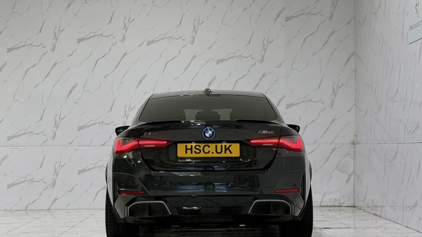 2022 BMW i4 — Rear view showing the tail lights and lower valance