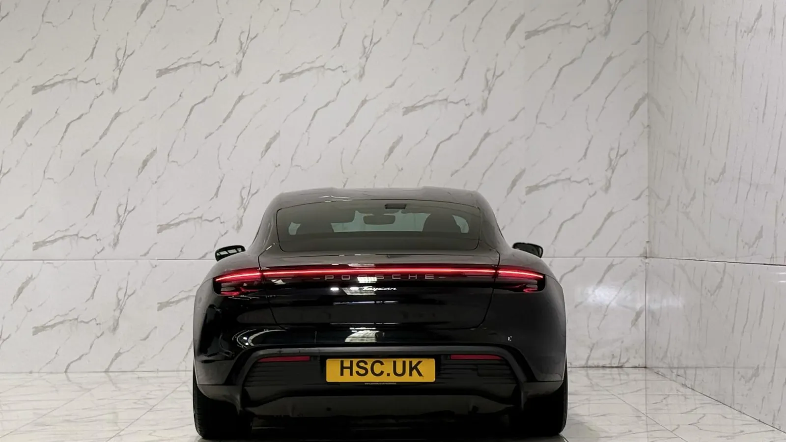 2022 Porsche Taycan — Rear view showing the full-width light bar