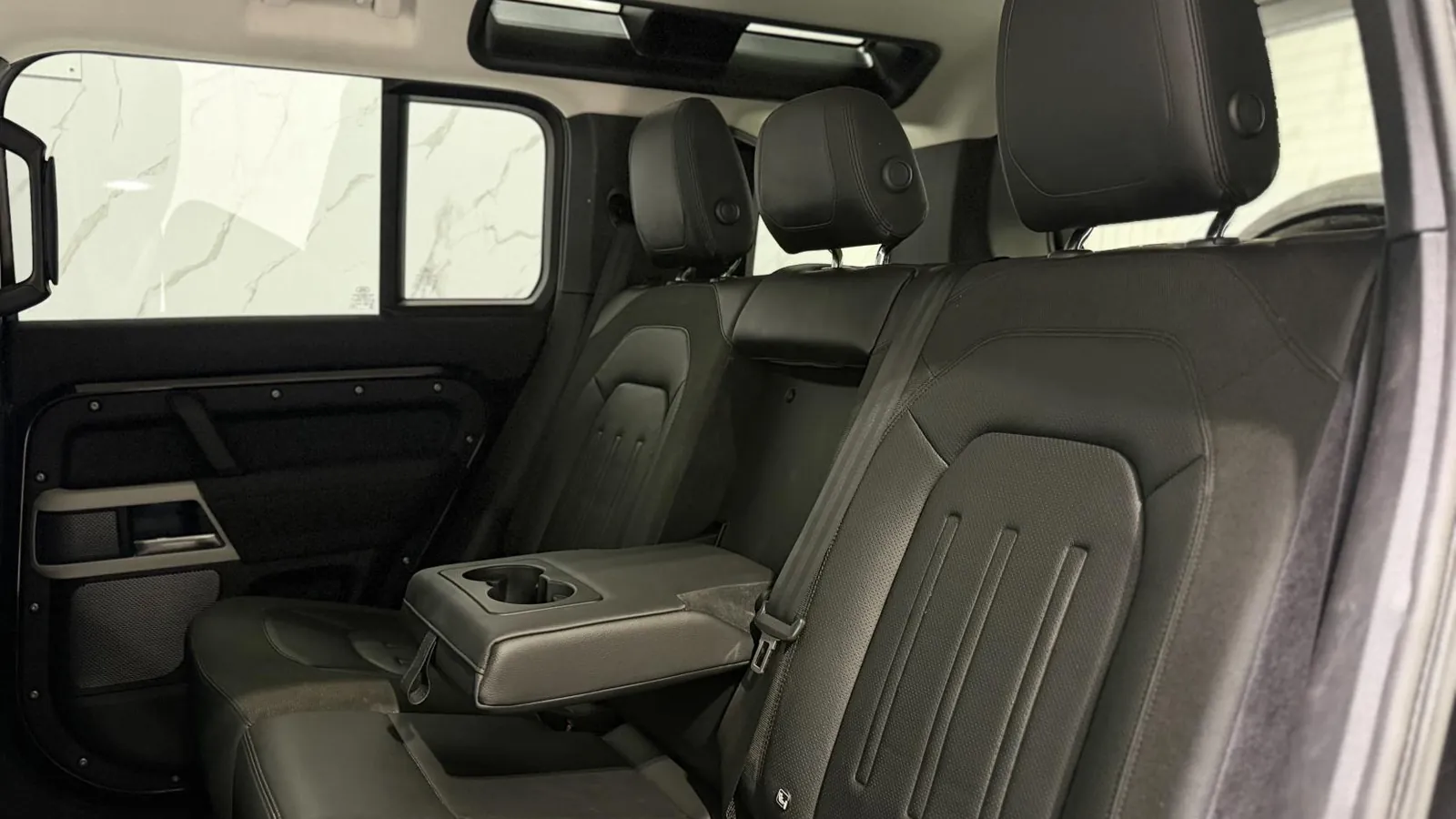 2020 Land Rover Defender 110 — Second-row bench with the centre armrest folded down