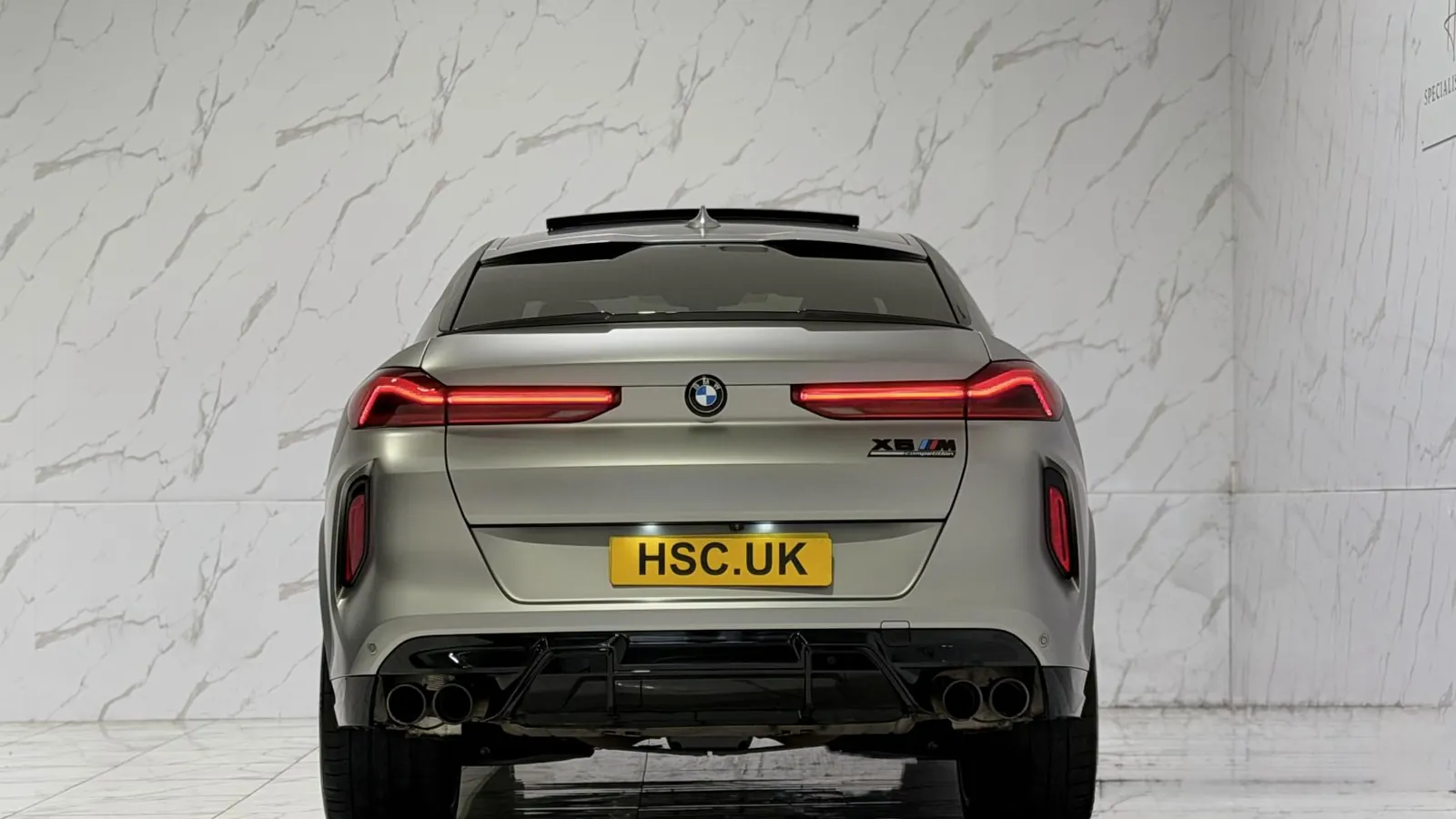 2022 BMW X6 M — Rear view showing the tail lights and quad exhaust outlets