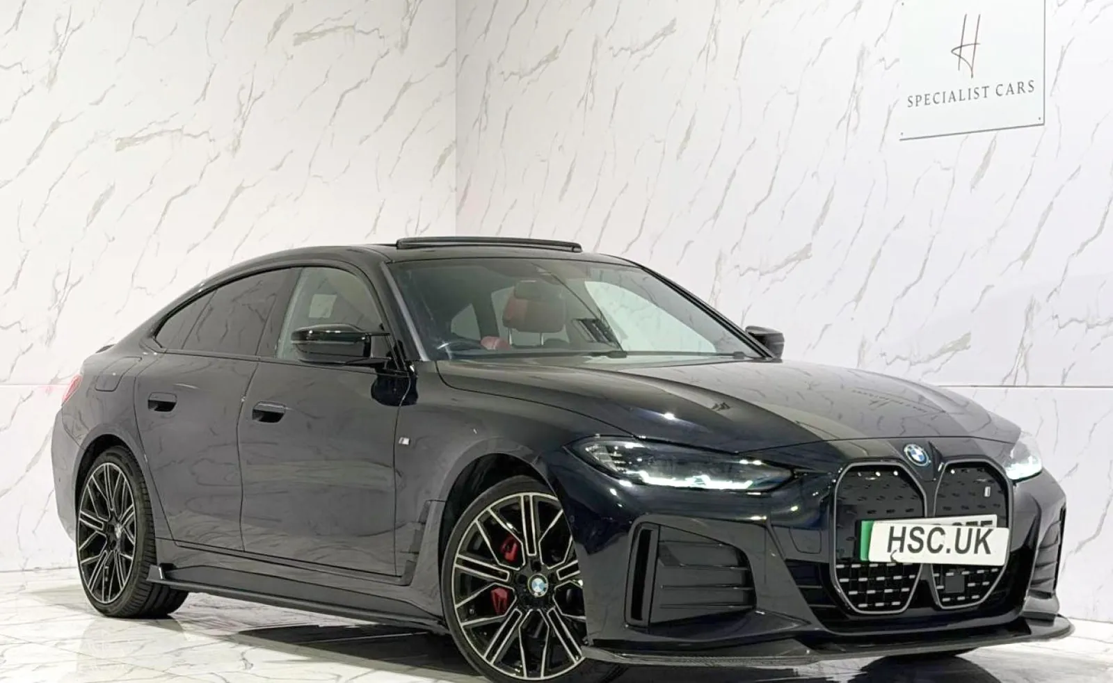 2023 BMW i4 — Front three-quarter view of the black i4 on the showroom floor