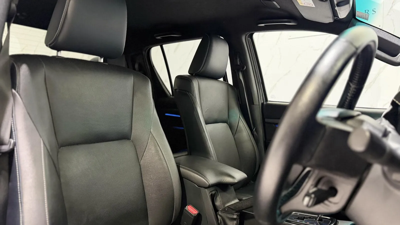 2023 Toyota Hilux — Front seats and steering wheel from the rear offside