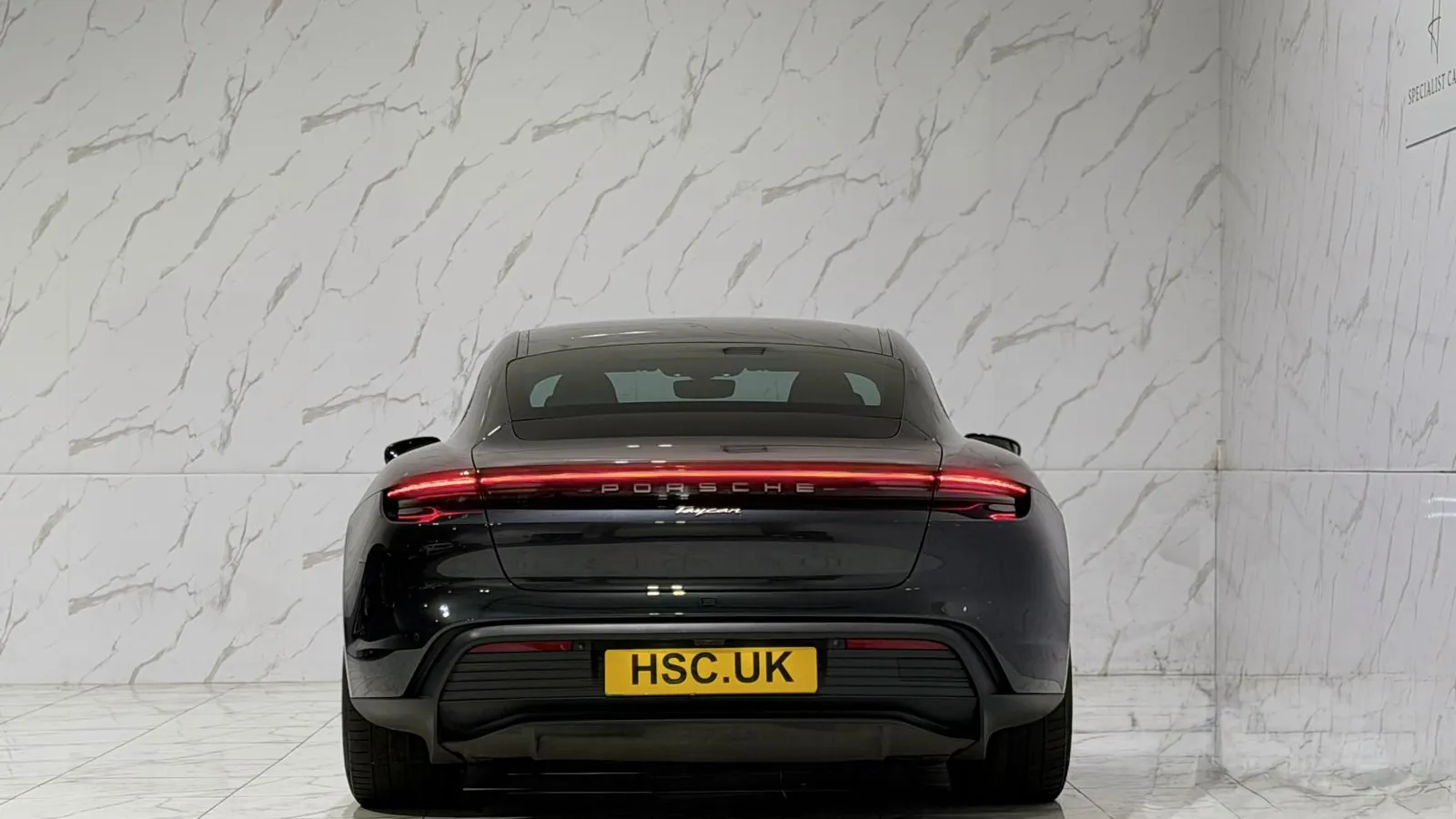 2022 Porsche Taycan — Rear view showing the full-width light bar