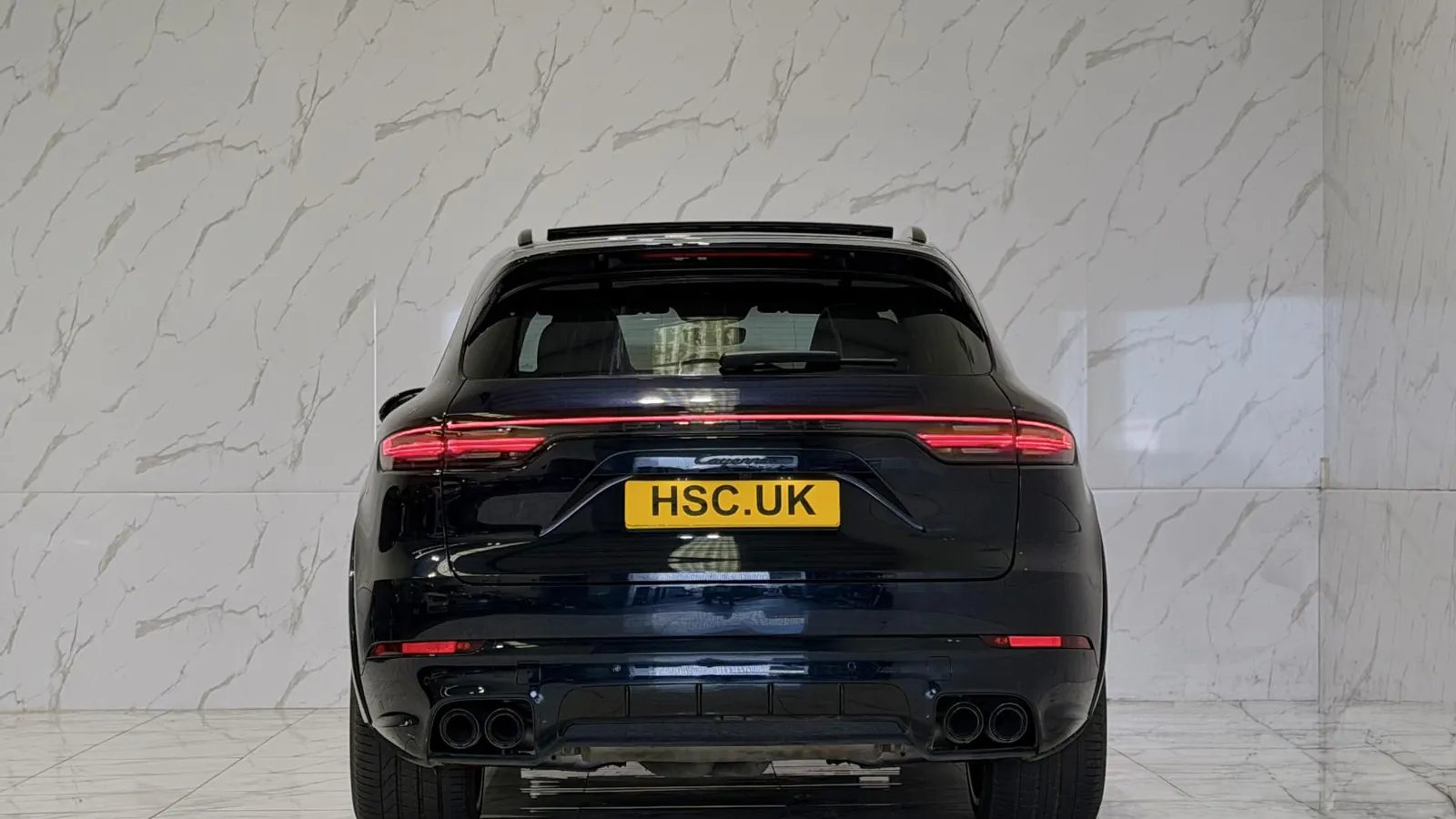 2023 Porsche Cayenne — Rear view showing the light bar and twin exhaust outlets